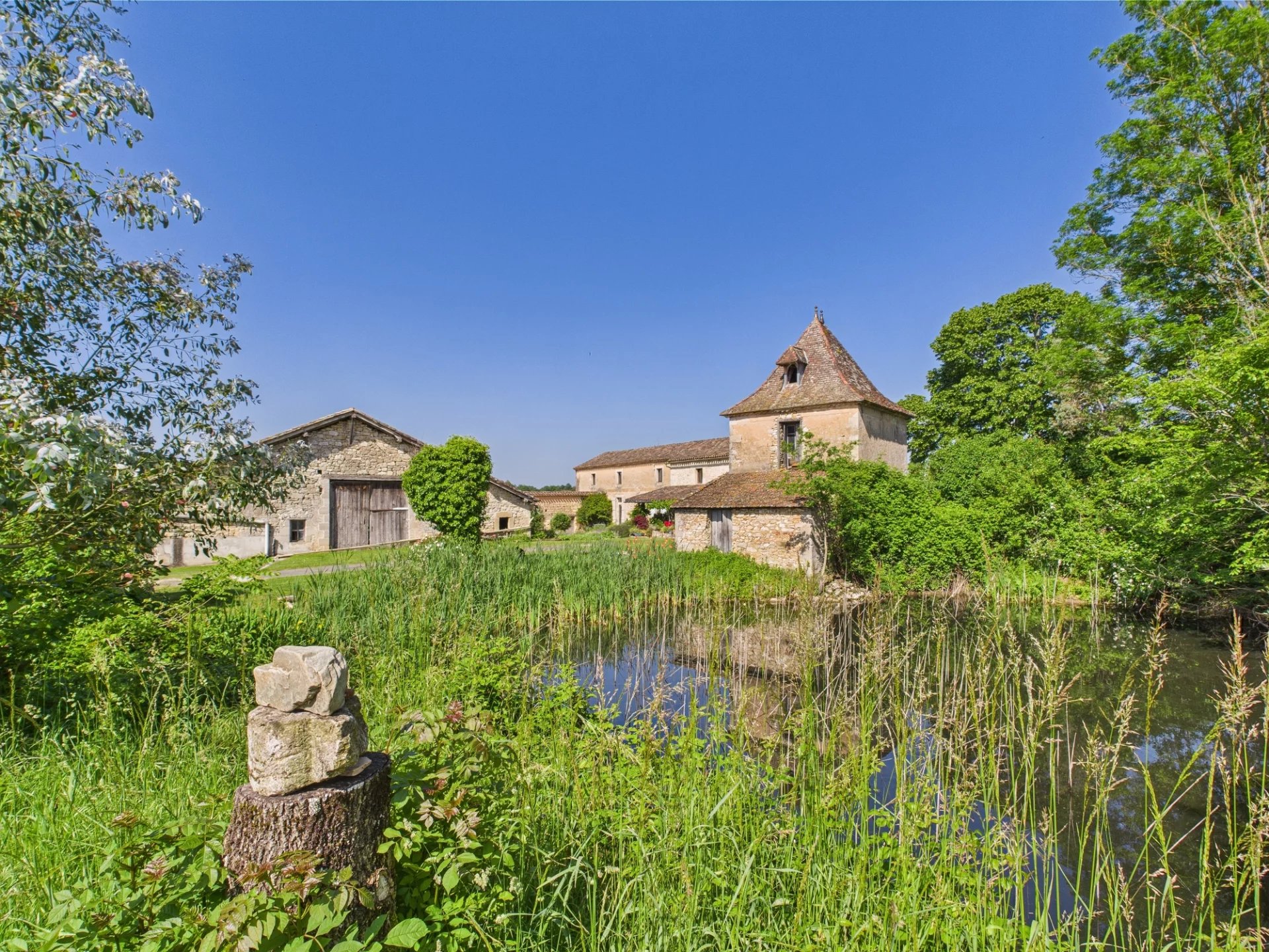 Charming house and outbuildings surrounded by a lush garden