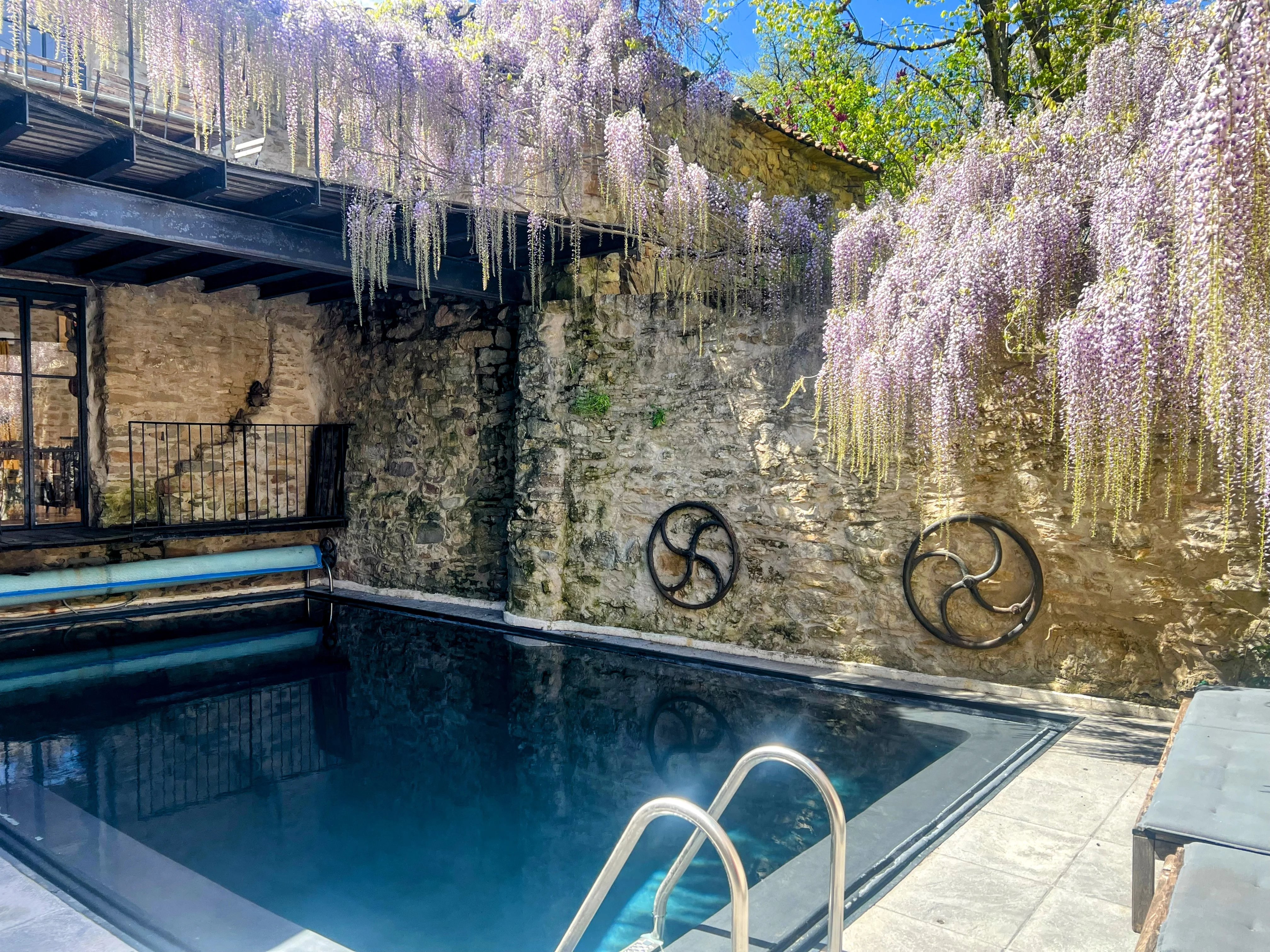 3 stone village properties centered around a courtyard with pool
