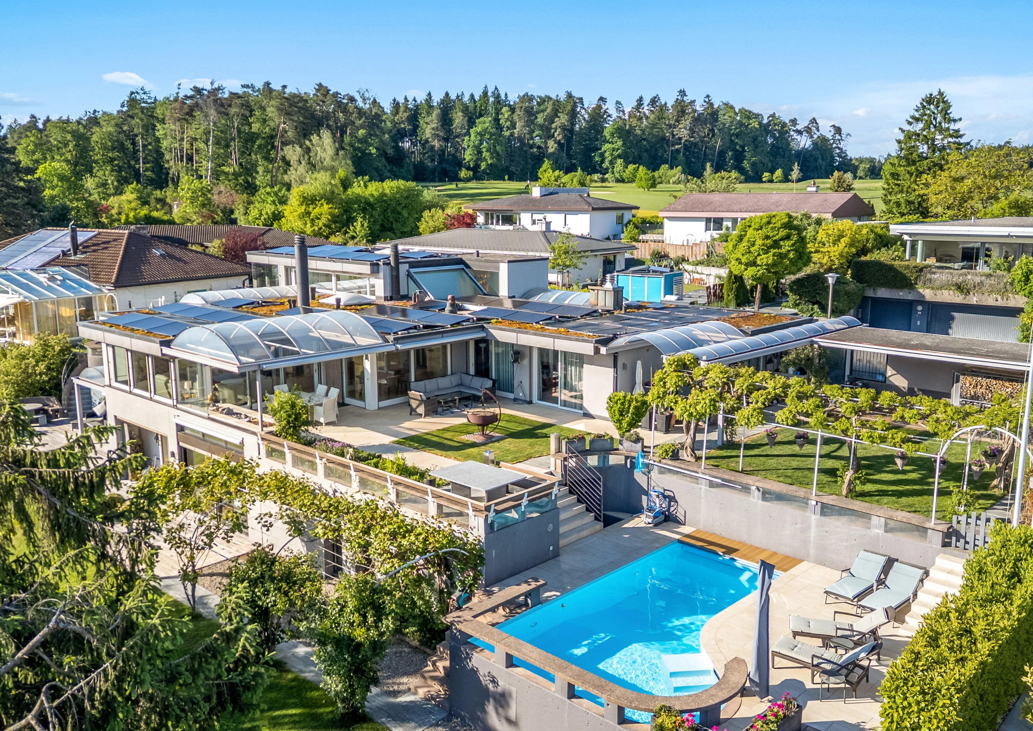 A timeless designer villa on a sunny hillside with a stunning garden