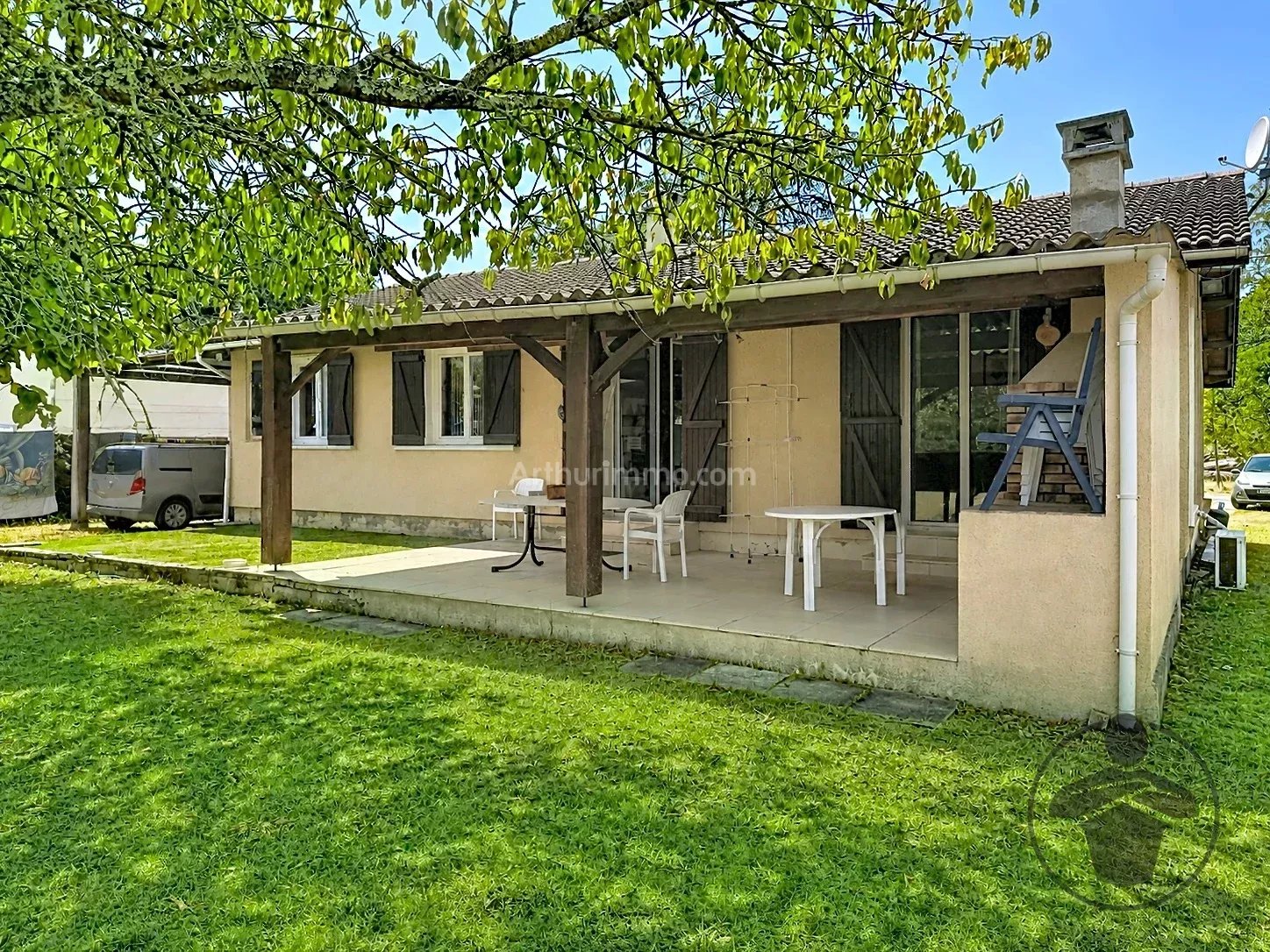 Maison de plain-pied avec terrasse couverte et grand terrain arboré