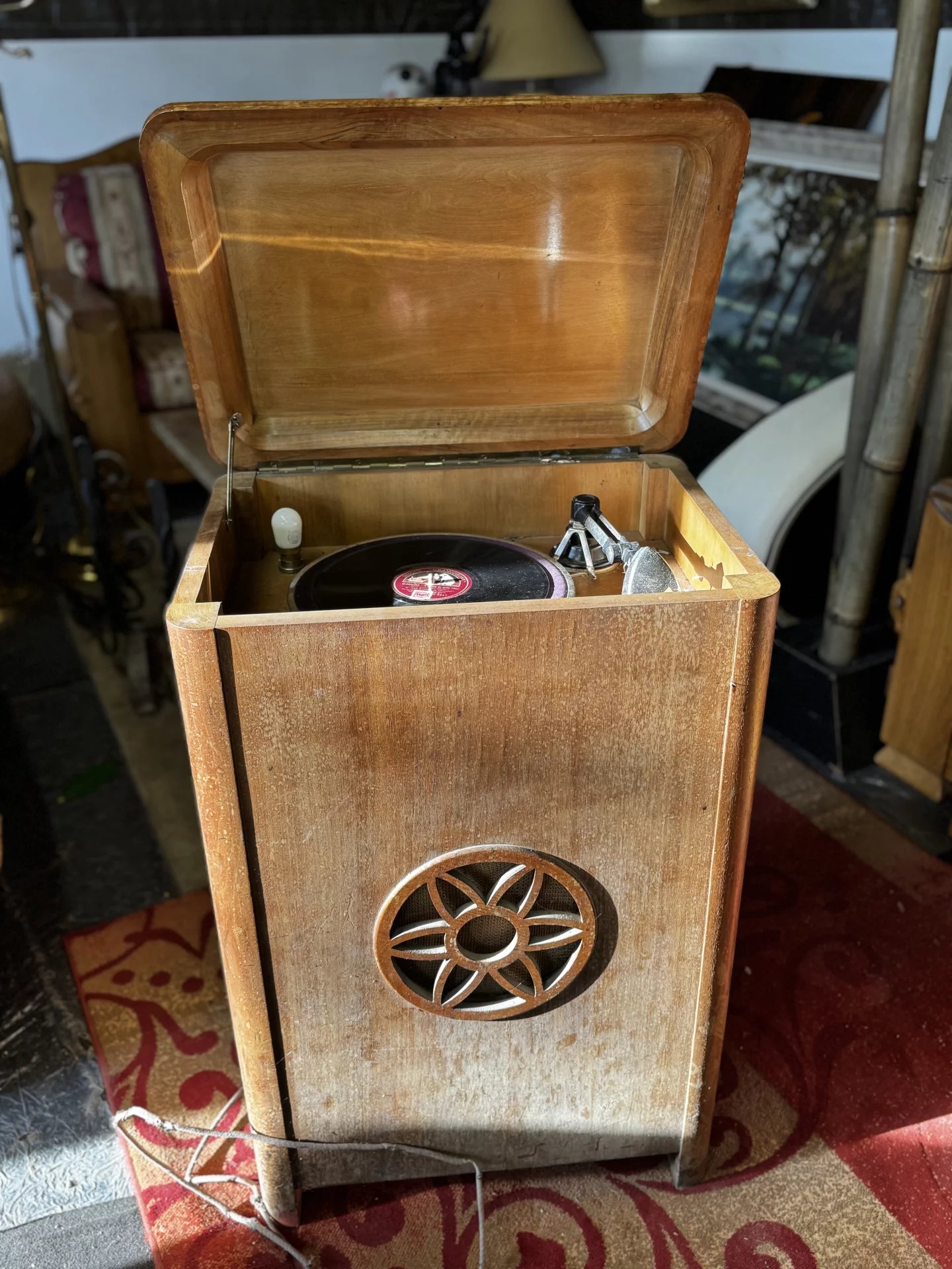 Antique 78 rpm record player integrated into its cabinet