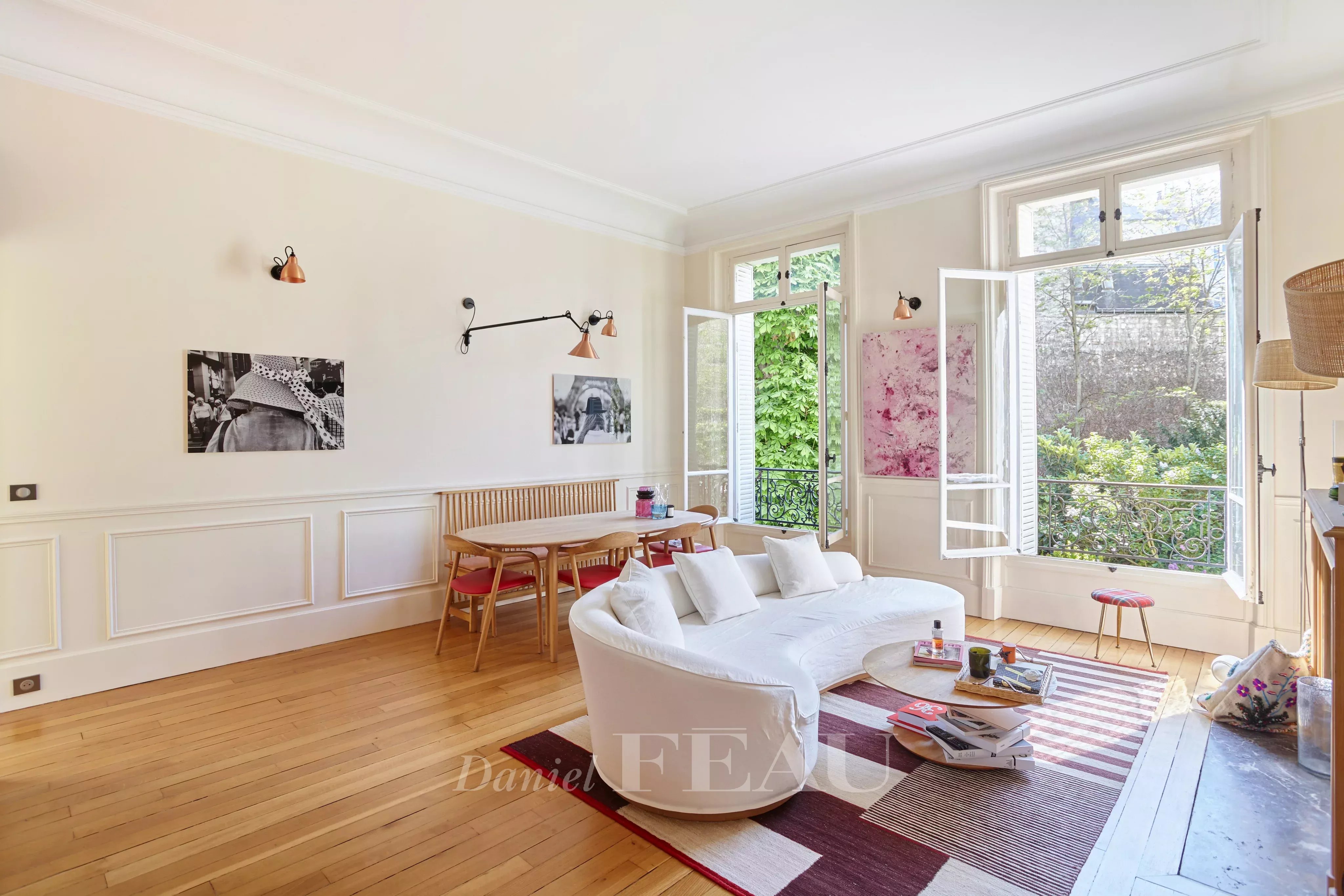 Living room with a view over a garden, wooden floor, fireplace