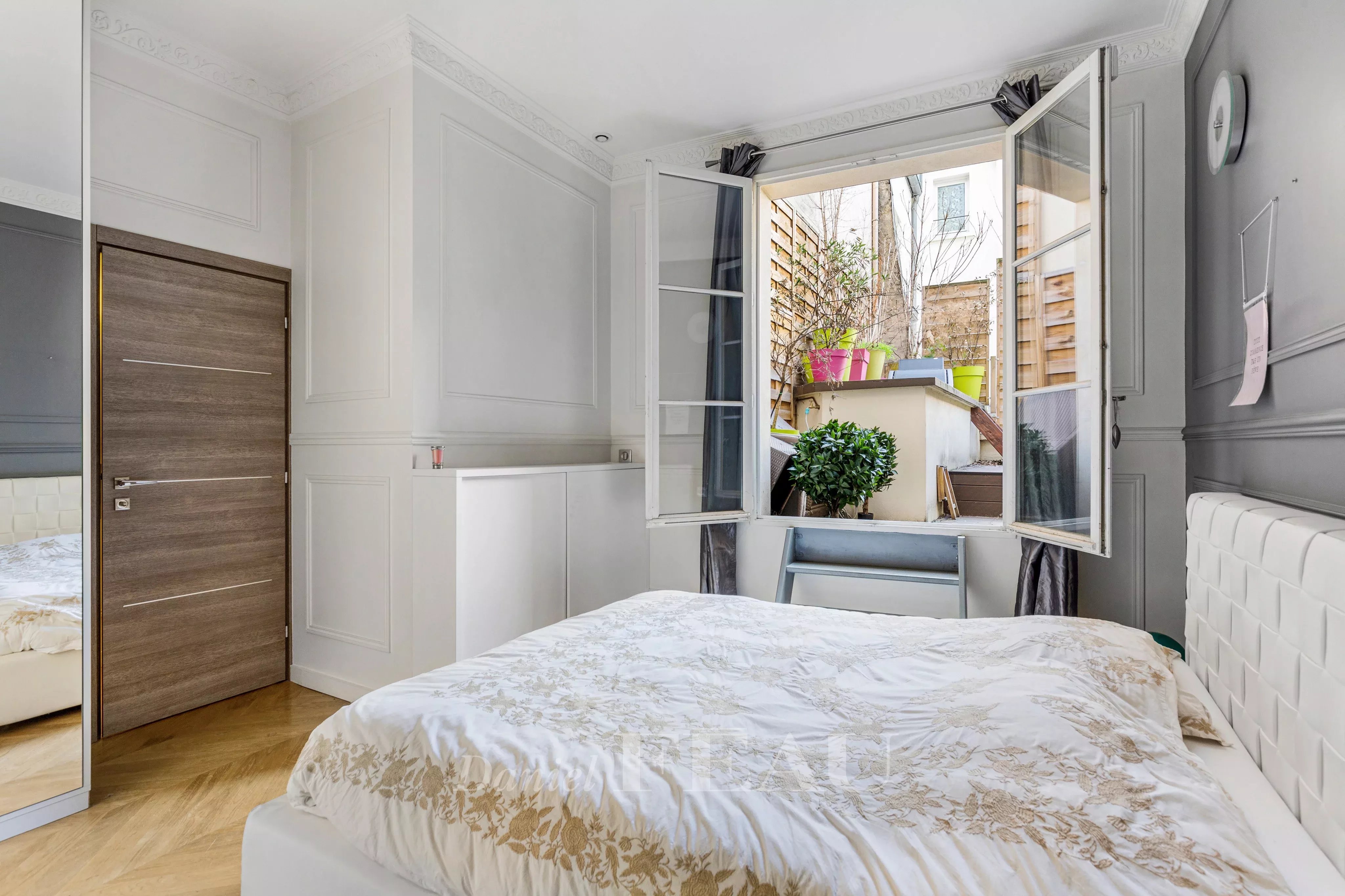 Bedroom opening onto a terrace, wooden floor