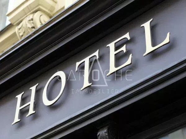 The metallic hotel sign on the wall