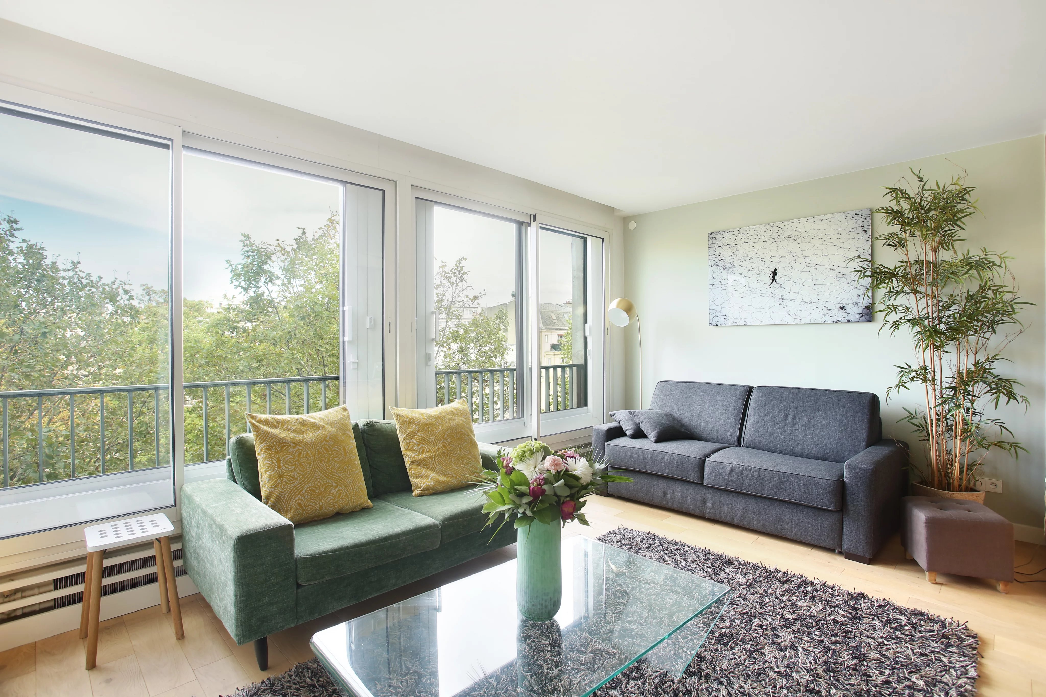 Bright living room with a view on the Hotel Salomon de Rothschild, wooden floor