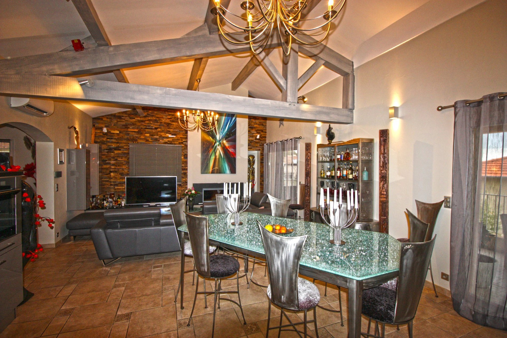 Dining room Chandelier Exposed bricks Fireplace Natural light Kitchen bar Tile
