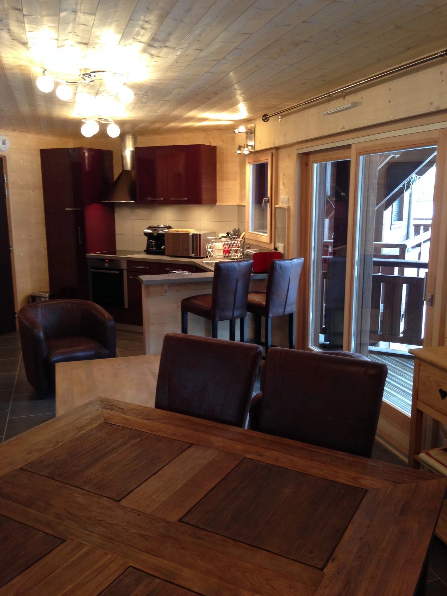 Living-room Natural light Kitchen bar Tile Wooden floor