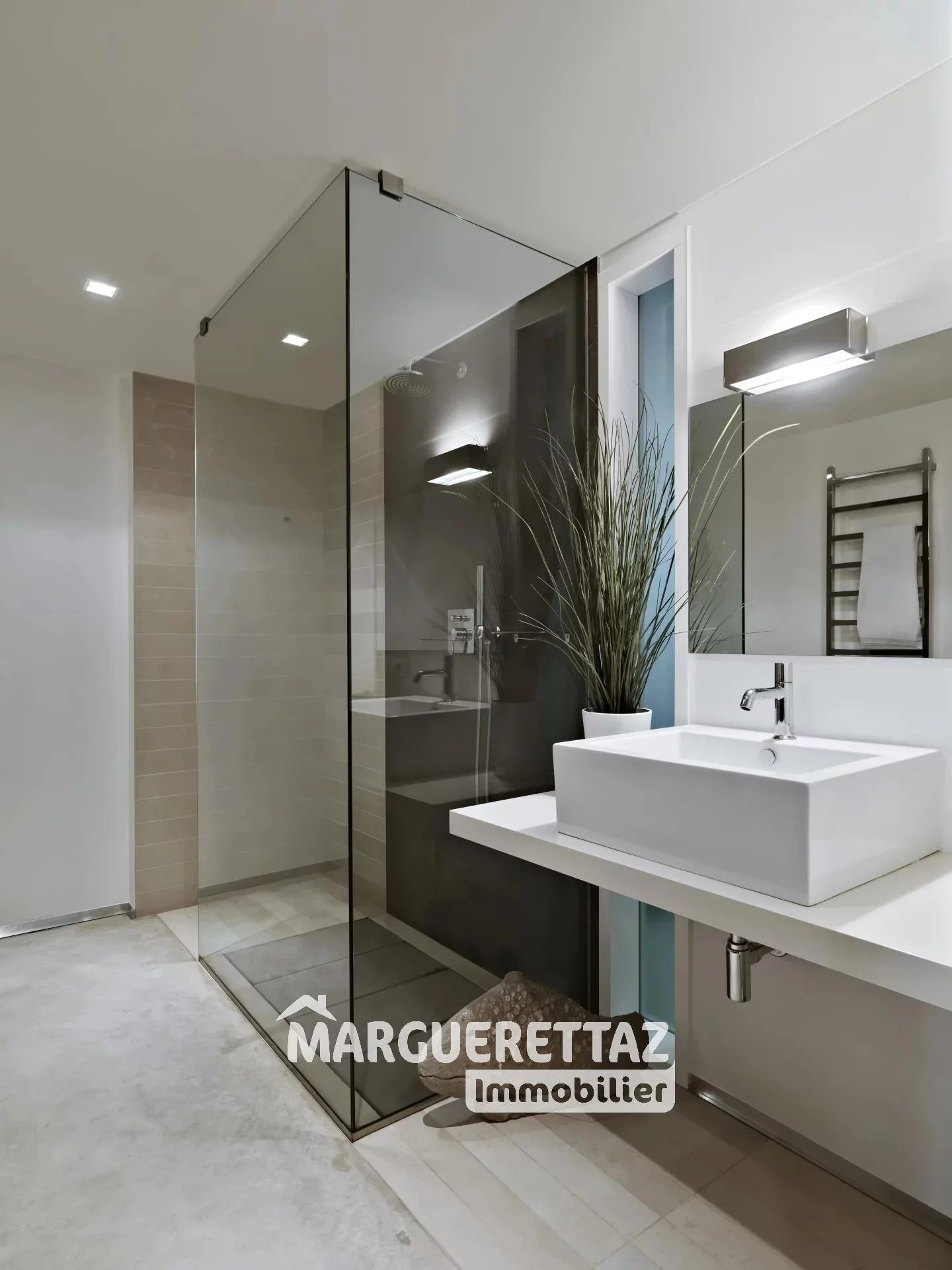 interior shots of a modern bathroom in foreground the countertop washbasin and the glass shower box