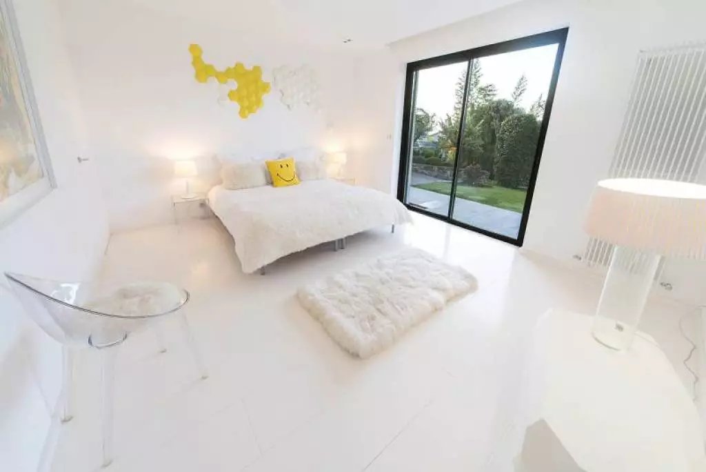white bedroom with smiling pillow