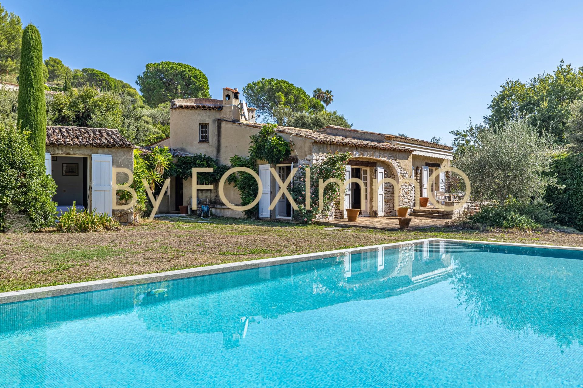 Villa provenzale indipendente, piscina a sfioro, giardino pianeggiante, quartiere residenziale.