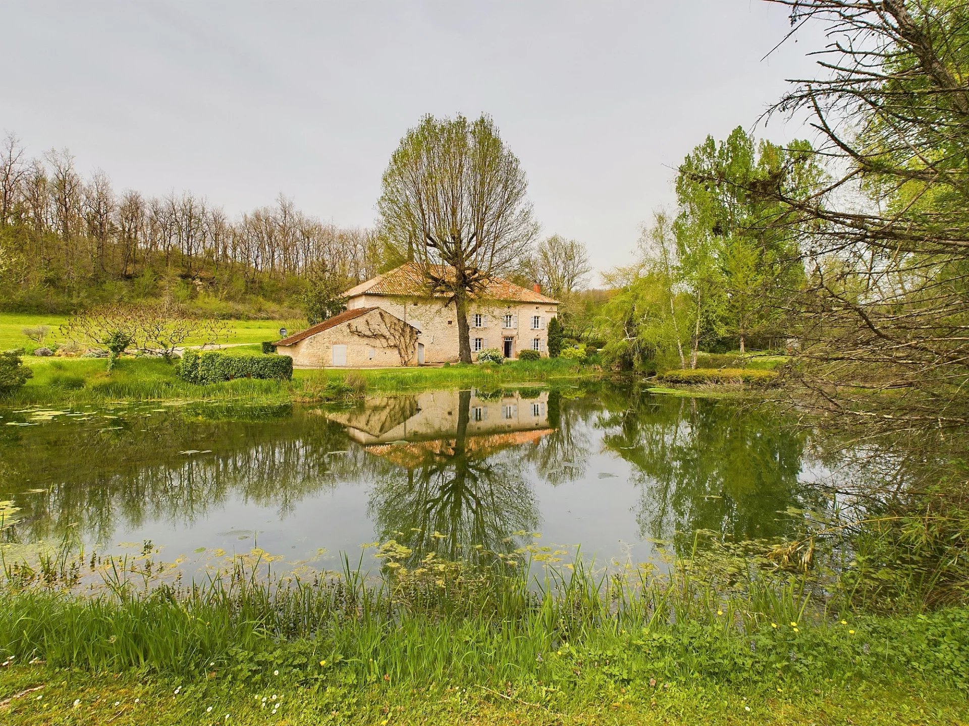 Beautiful restored water mill with lake and land